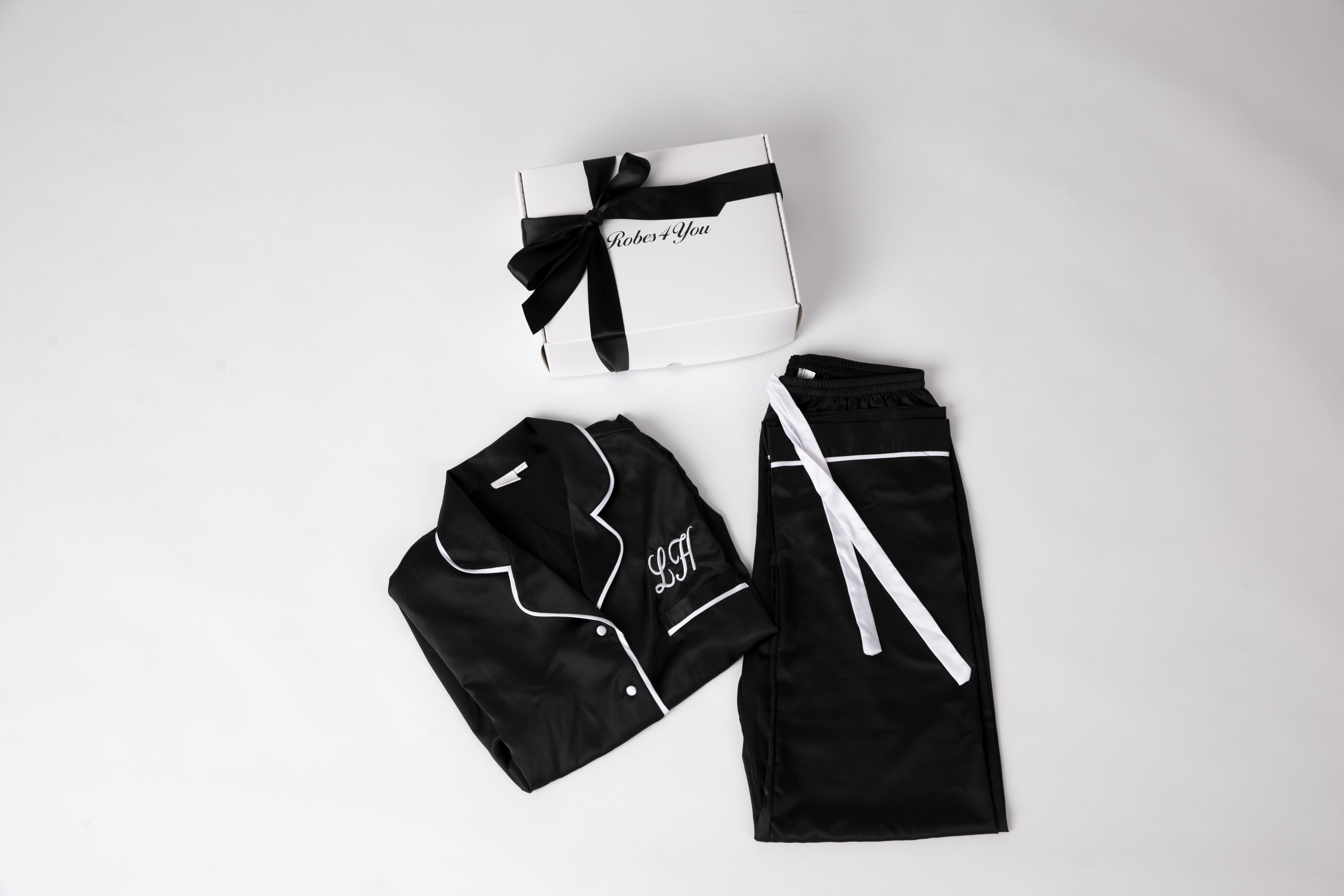 Personalised Black Satin Pjs with Black Piping with Chocolates and Candle & Snippet of Champagnepresented in a gift box with bow